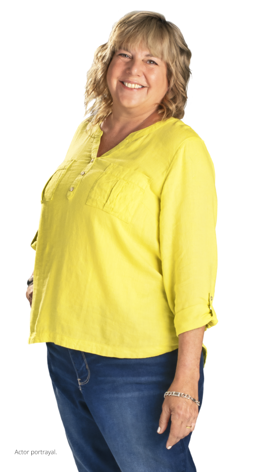 Woman in yellow standing and smiling (actor portrayal)